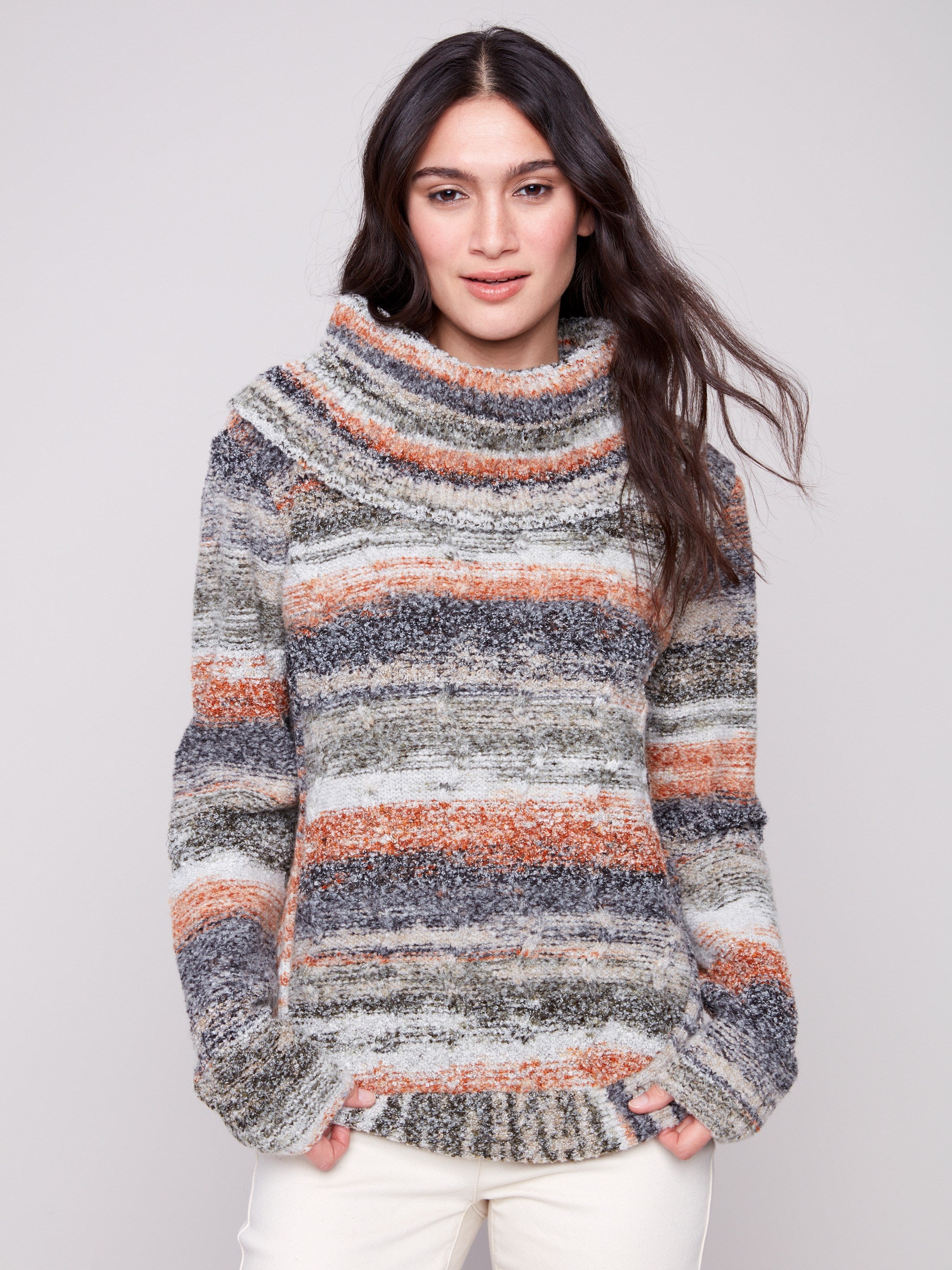 Autumn-hued sweater with a cozy cowl neck and intricate cable knit detailing, perfect for chilly days by Charlie B.