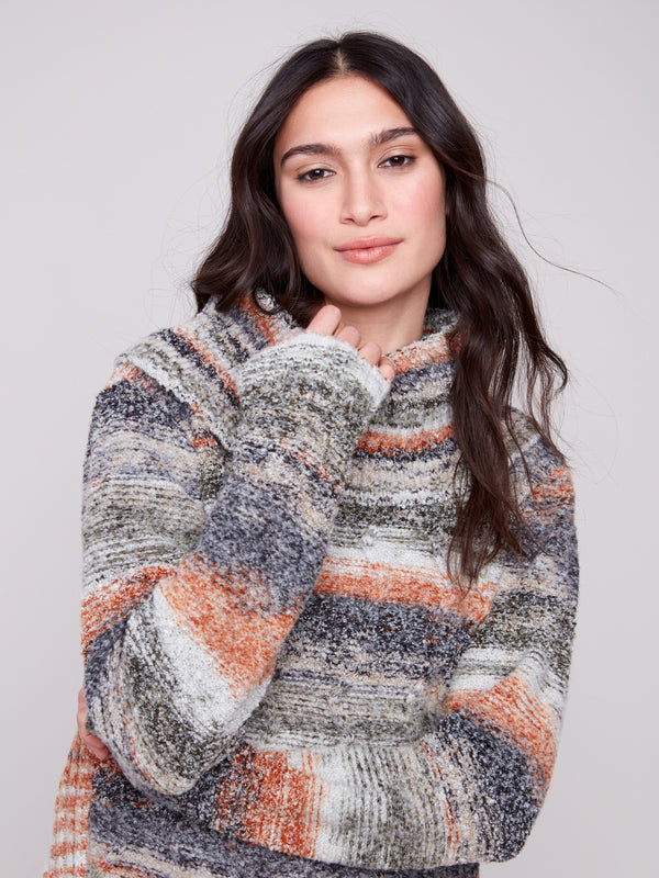 Elegant cable knit sweater in warm autumn tones, ideal for adding texture to your wardrobe by Charlie B.