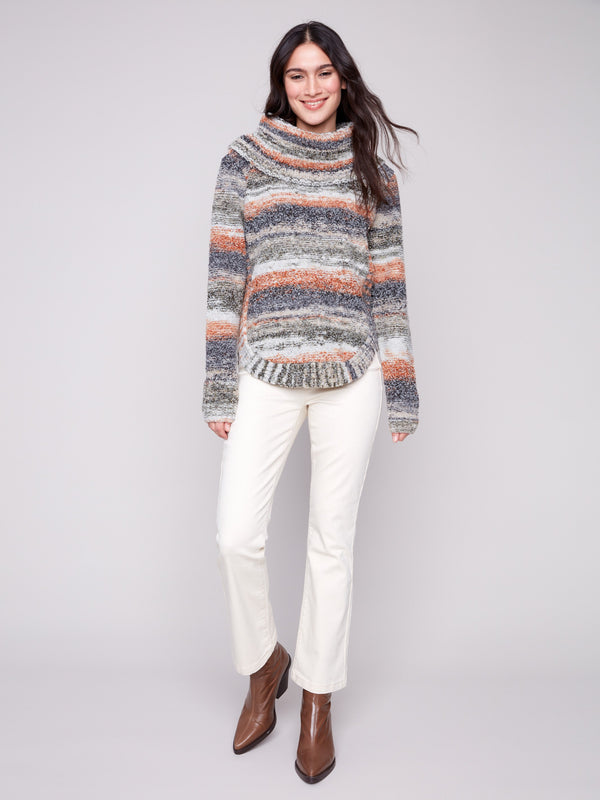 Autumn-inspired cable knit design adds depth to this cozy striped sweater, perfect for layering by Charlie B.
