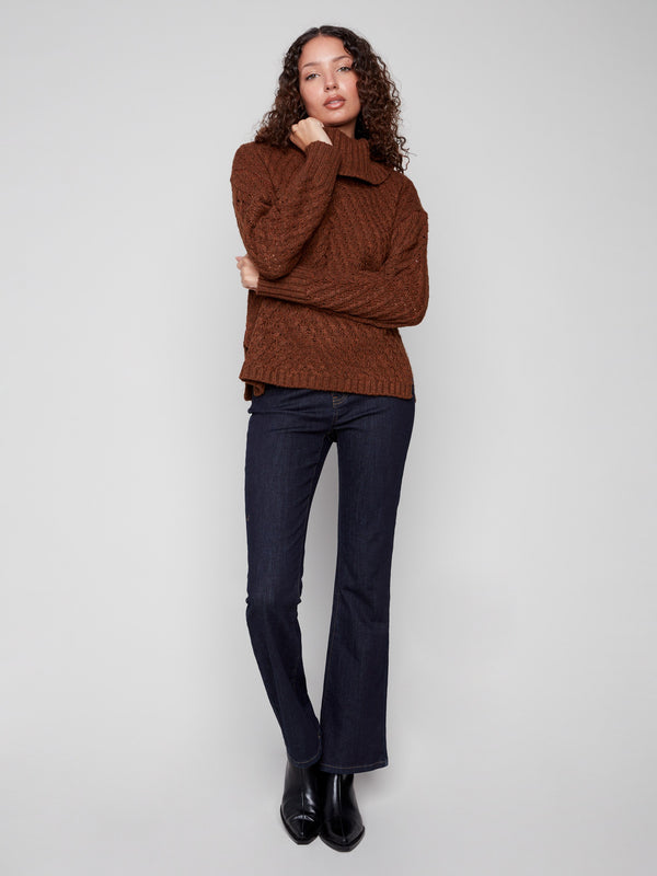 Chic sepia sweater with a stylish slit hem, adding a modern touch to the classic cable knit design by Charlie B.