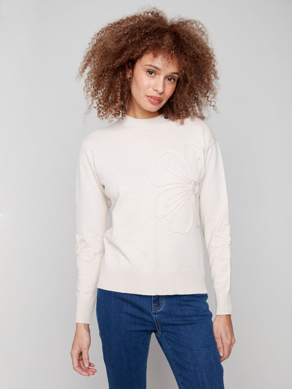 Heather Oat sweater featuring a classic crew neck design and intricate floral detail on the sleeves, offering timeless style by Charlie B.