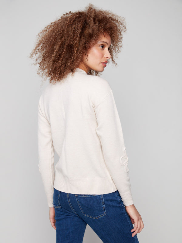 Stylish Heather Oat sweater showcasing exquisite floral soutache accents on sleeves, paired with a cozy crew neck by Charlie B.