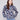 Navy blue sweater featuring dolman sleeves and a vibrant floral jacquard design, perfect for cozy elegance by Charlie B.