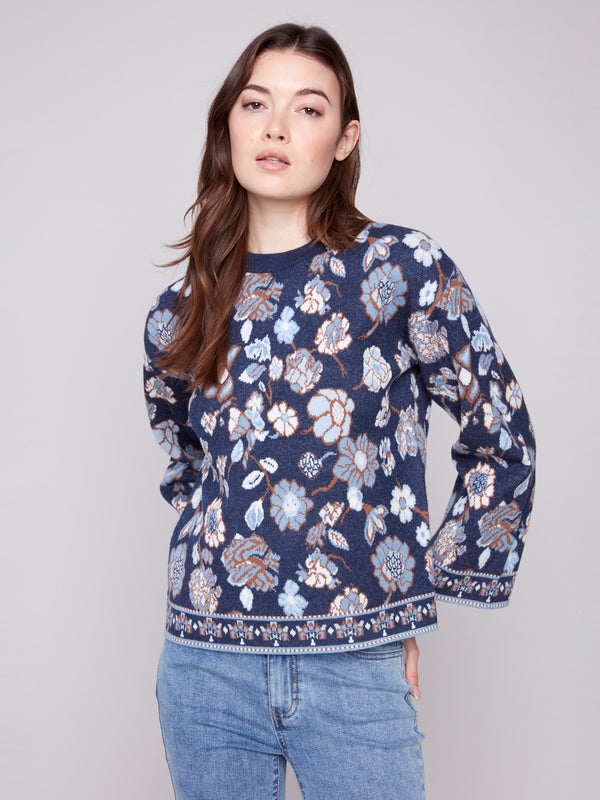 Charming navy blue sweater adorned with a detailed floral pattern and comfortable crew neck design by Charlie B.