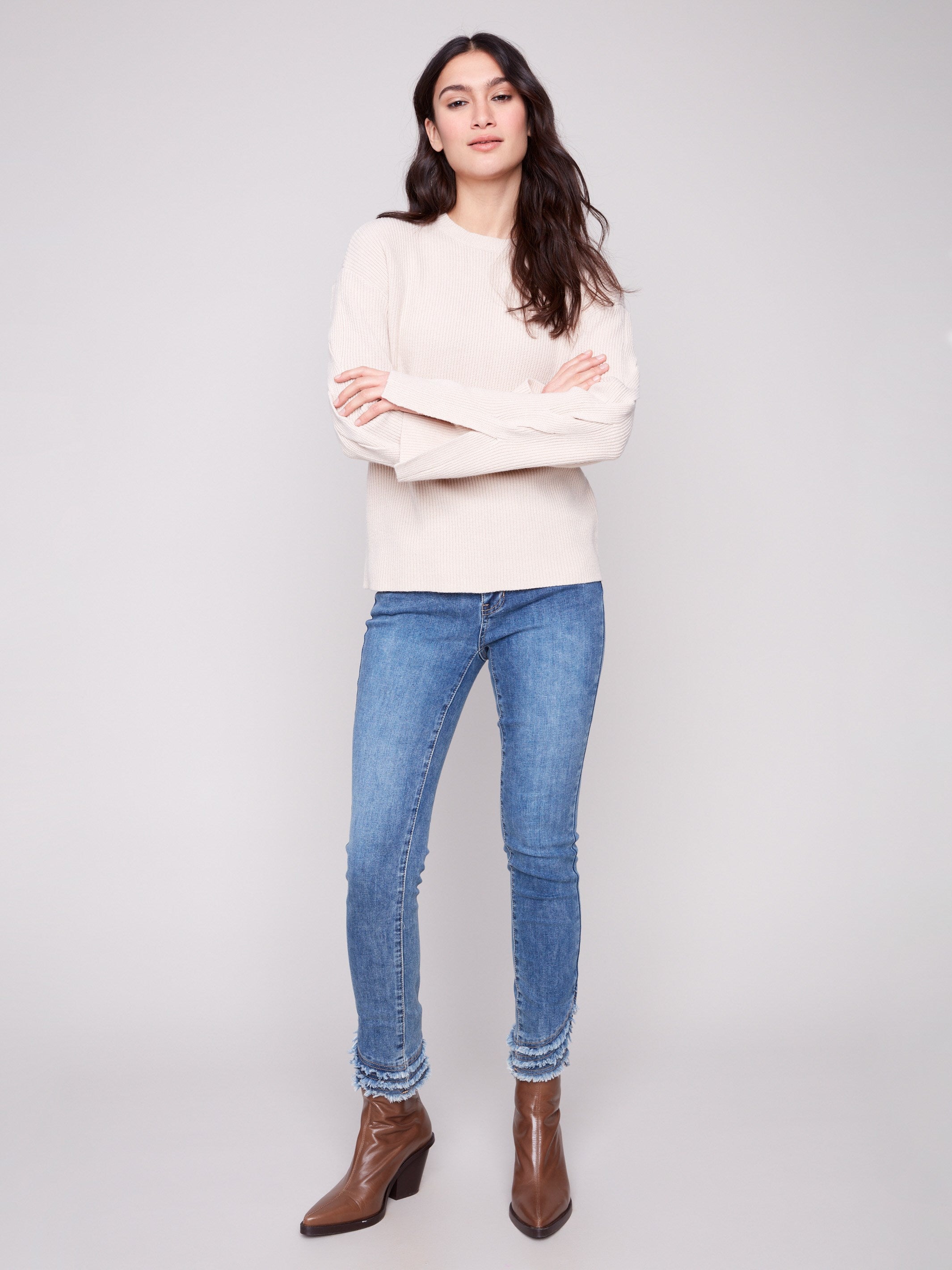 This heather oat sweater showcases elegant cable details on the sleeves, perfect for a chic look by Charlie B.