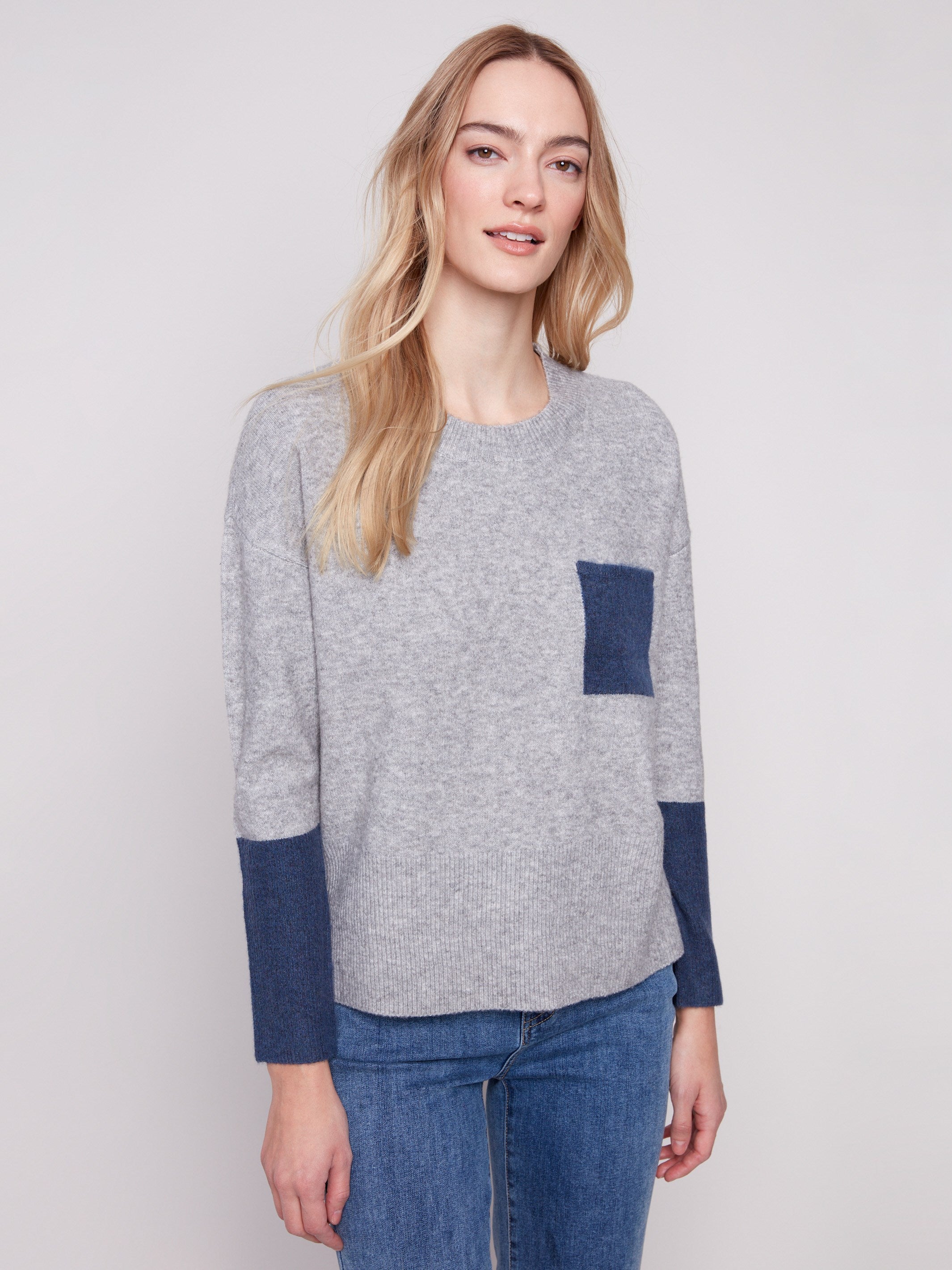 Heather grey sweater featuring a classic crew neck design and navy accents adds a stylish touch to any outfit by Charlie B.