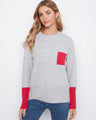 This sweater features a relaxed fit with a charming red pocket detail, adding a pop of color to your casual ensemble by Charlie B.