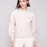 Oat sweater with white floral embroidery, highlighting the crew neck design for a classic look by Charlie B.