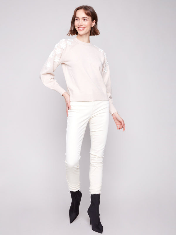Sweater in heather oat featuring raglan puff sleeves and delicate floral embroidery by Charlie B.