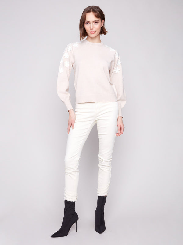 Chic crew neck sweater in heather oat, detailed with exquisite white flower embroidery by Charlie B.