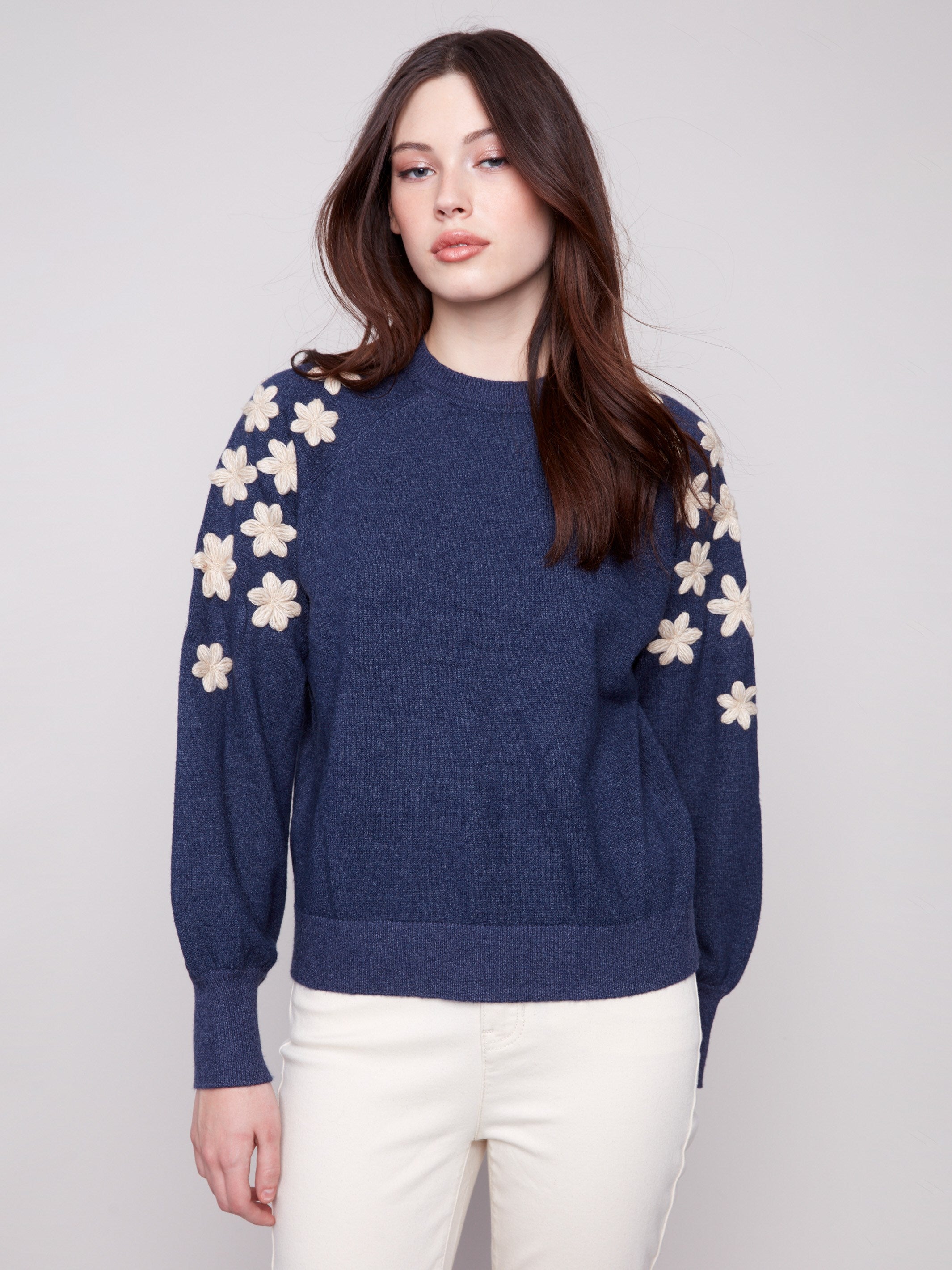 Denim sweater featuring raglan puff sleeves and floral embroidery, showcasing ribbed cuffs for a cozy fit by Charlie B.