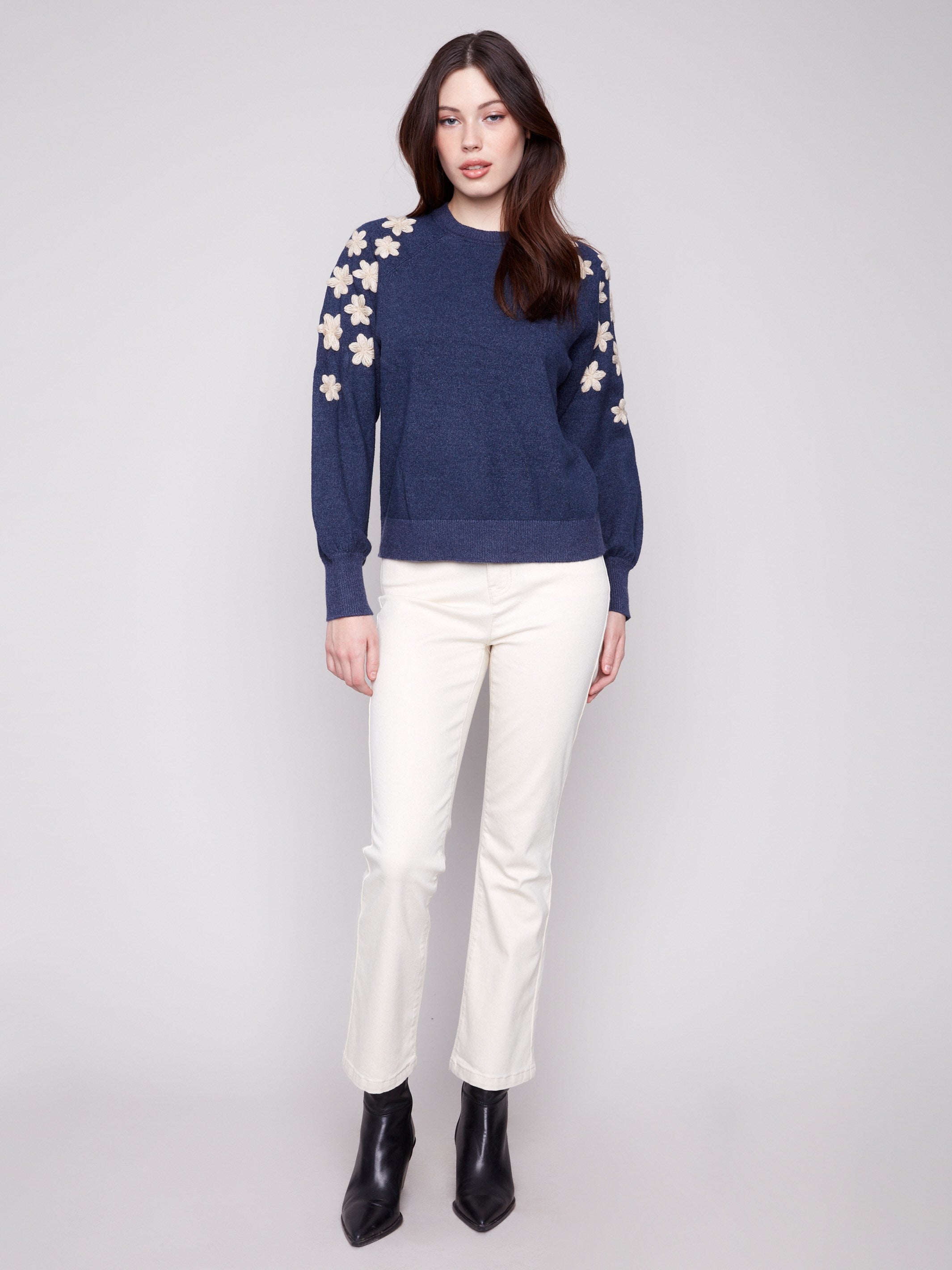 Stylish heather denim sweater with ribbed hem and delicate embroidered flowers for a chic look by Charlie B.