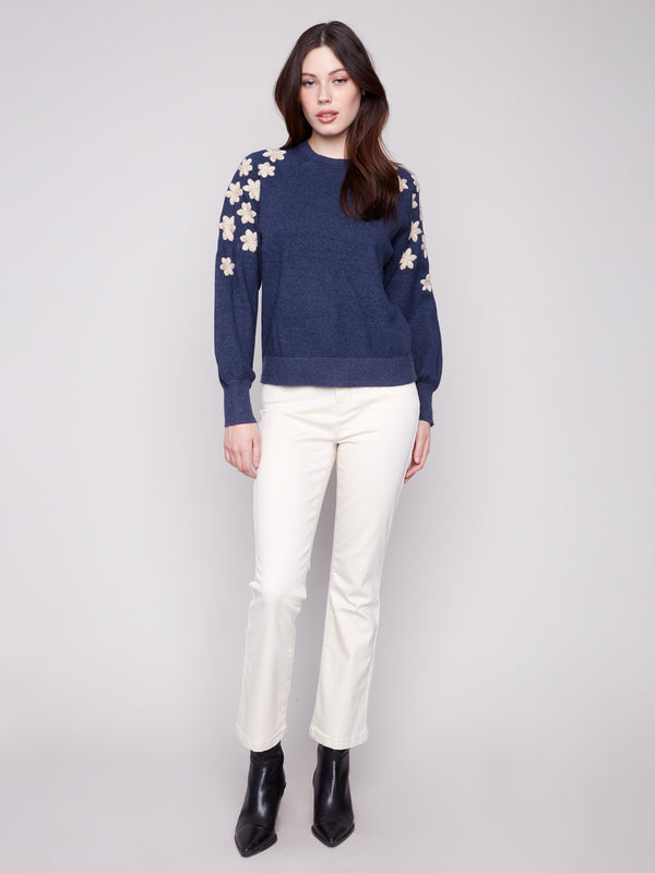 Stylish crew neck sweater in heather denim with beautiful floral details and raglan puff sleeves by Charlie B.