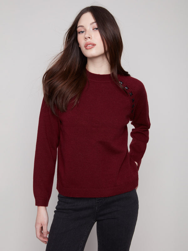 Chic cabernet sweater featuring faux leather detail at the armhole, adding a modern touch by Charlie B.