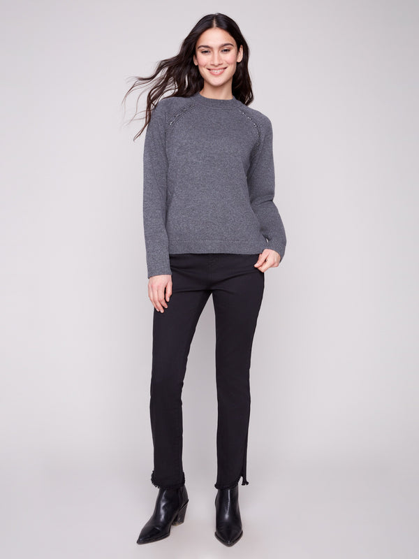 This charcoal sweater showcases raglan sleeves, offering a relaxed fit with elegant detailing by Charlie B.