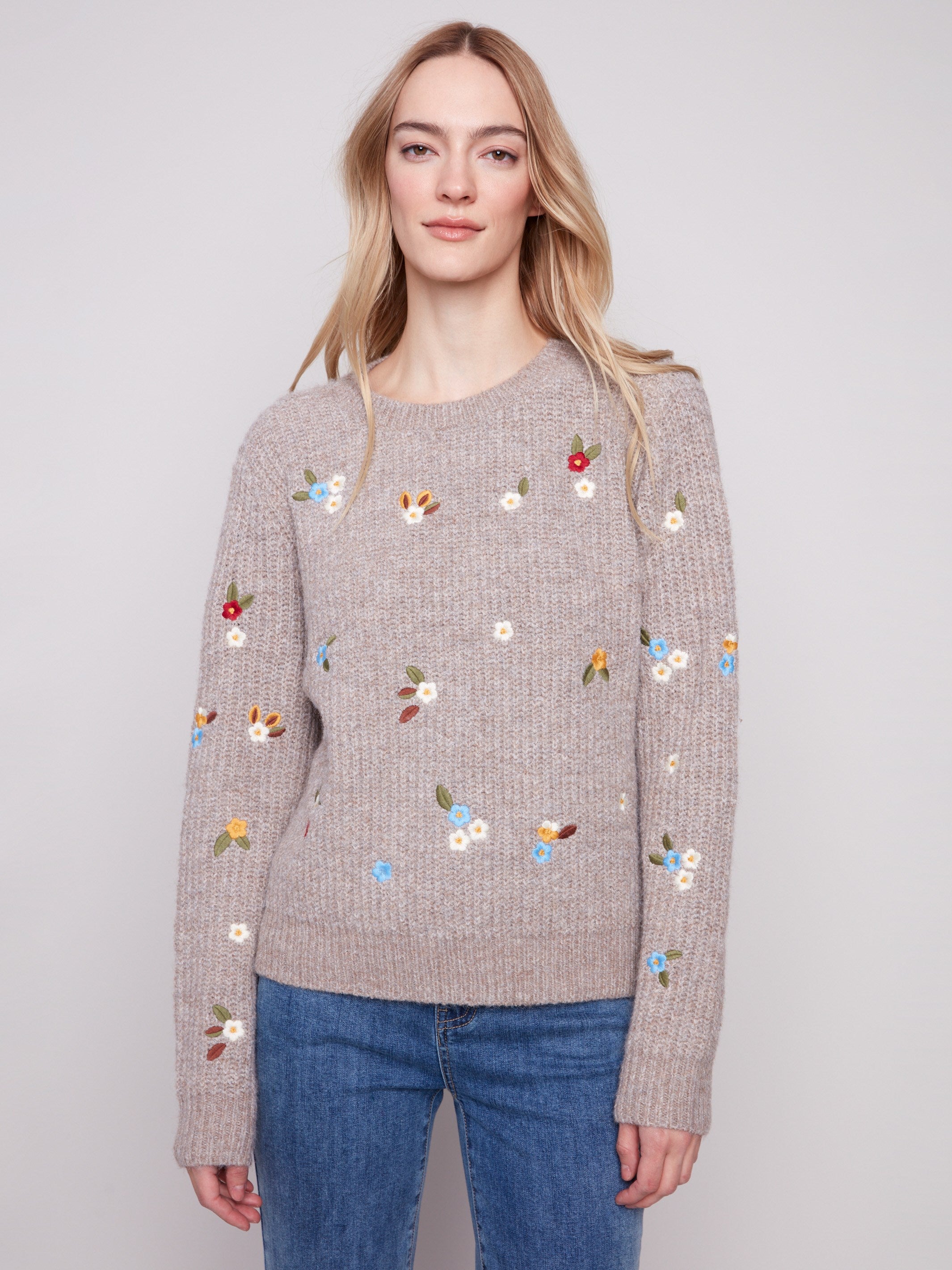 Light brown sweater with intricate floral embroidery, showcasing long sleeves and ribbed texture by Charlie B.