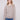 Light brown sweater with intricate floral embroidery, showcasing long sleeves and ribbed texture by Charlie B.