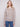 Light brown sweater with intricate floral embroidery, showcasing long sleeves and ribbed texture by Charlie B.