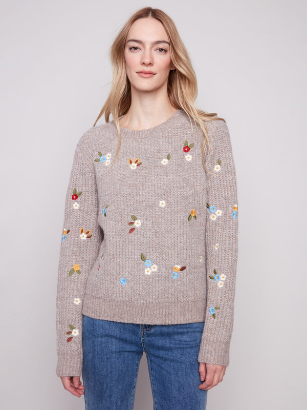 Light brown sweater with intricate floral embroidery, showcasing long sleeves and ribbed texture by Charlie B.