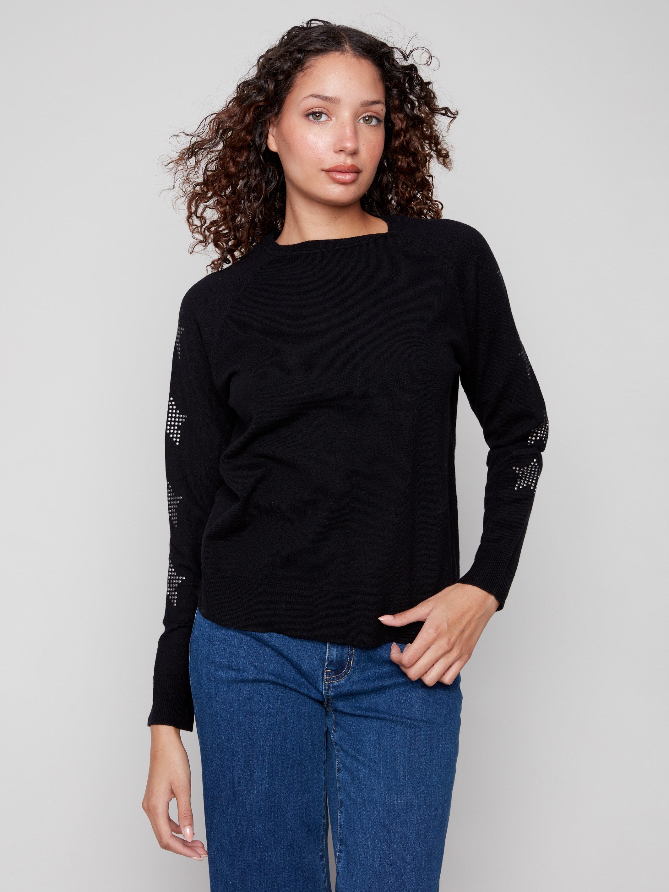 Black sweater with star stud details, showcasing its classic crew neck design. Perfect for casual outings. By Charlie B.