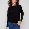 Black sweater with star stud details, showcasing its classic crew neck design. Perfect for casual outings. By Charlie B.