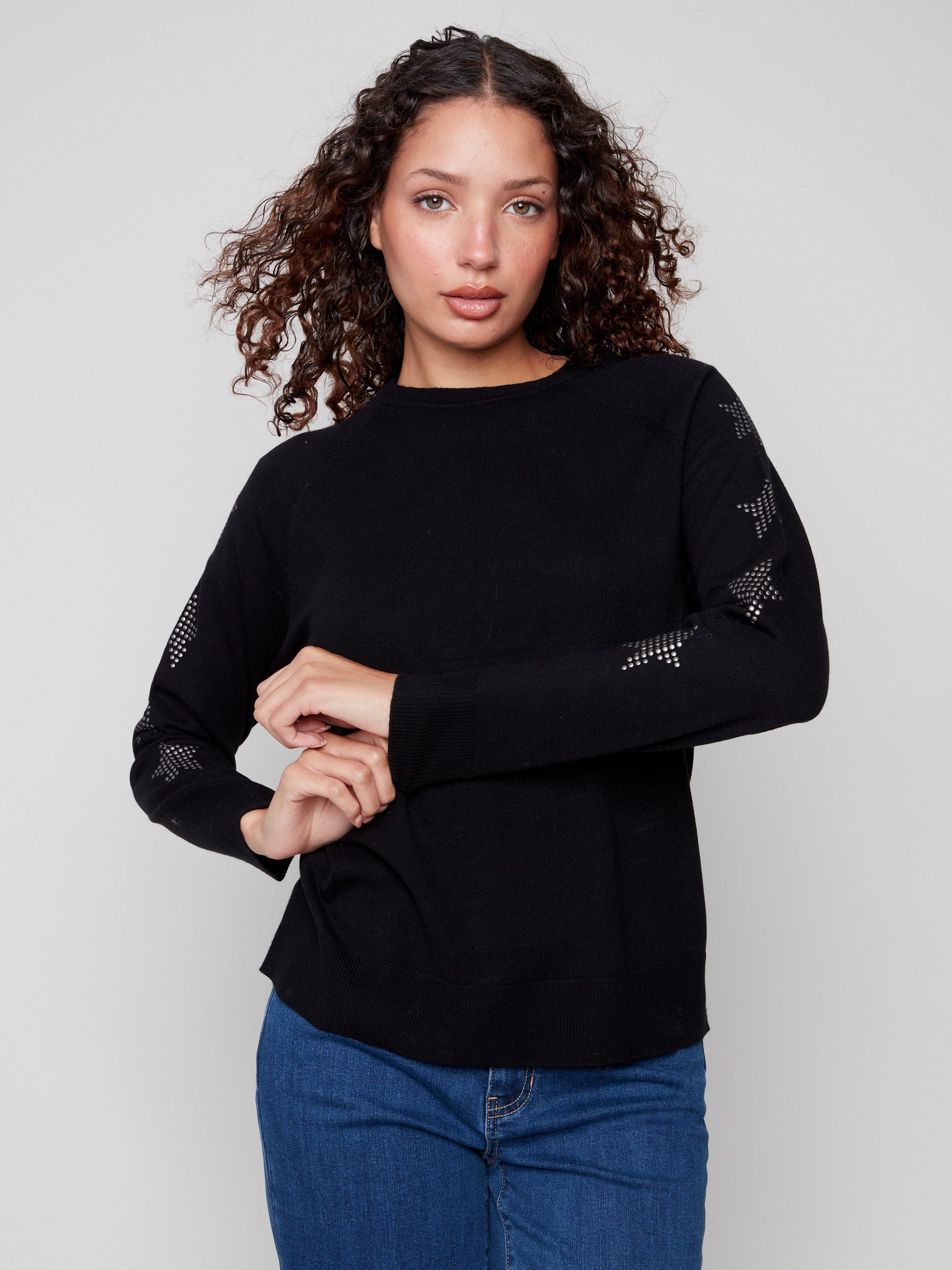 Elegant black sweater featuring raglan sleeves and stylish star studs, ideal for a chic look. Crafted by Charlie B.
