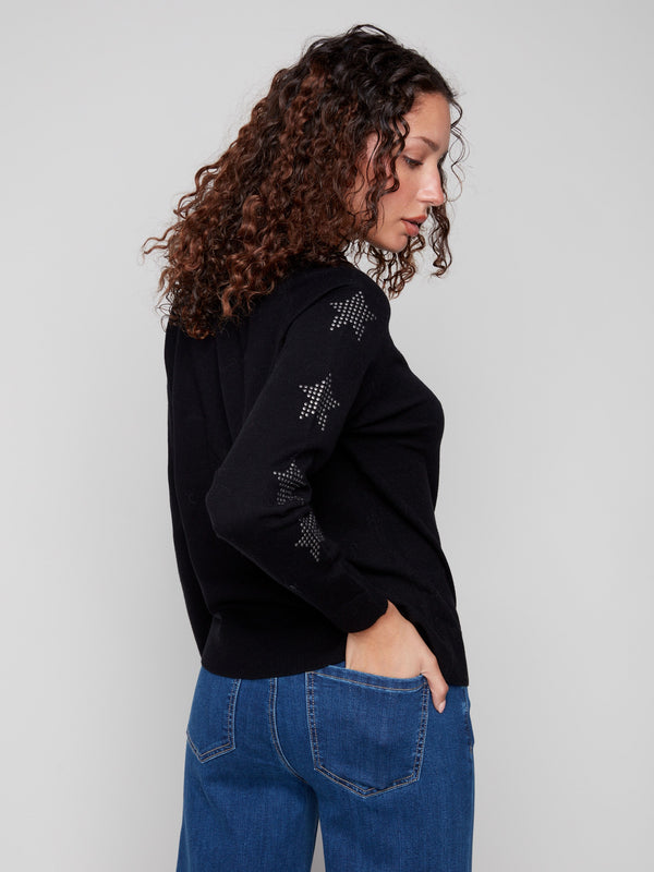 Chic black sweater adorned with sparkling star studs on the sleeves, offering a unique touch to your wardrobe. By Charlie B.