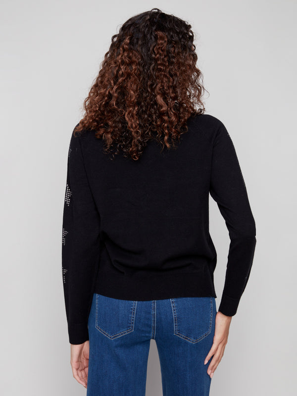 Versatile black sweater highlighted by its sleek design and eye-catching star stud details on the arms. Created by Charlie B.