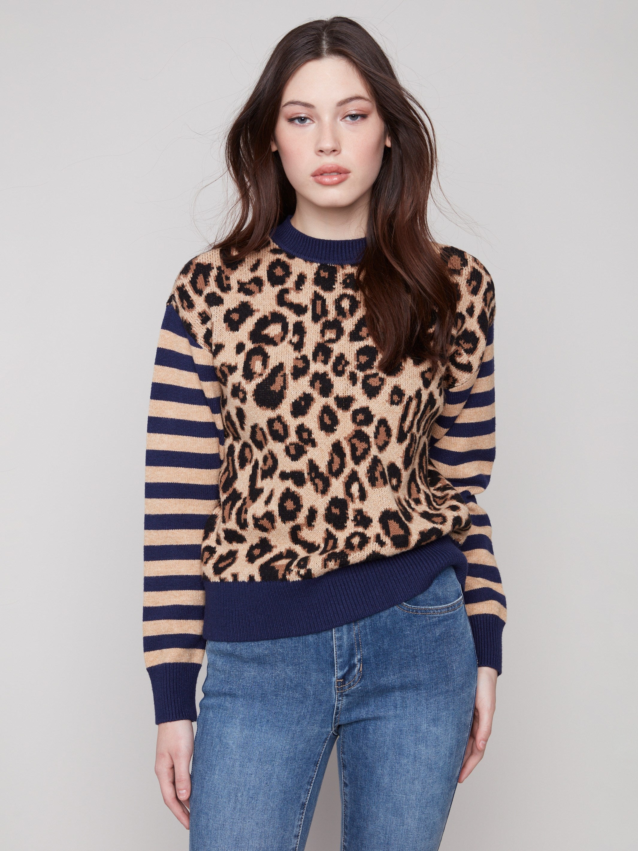 Sweater featuring a chic crew neck and bold leopard print design with striped sleeves, perfect for making a statement by Charlie B.