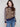 Casual chic sweater showcasing drop shoulders and vibrant leopard pattern paired with elegant stripes by Charlie B.