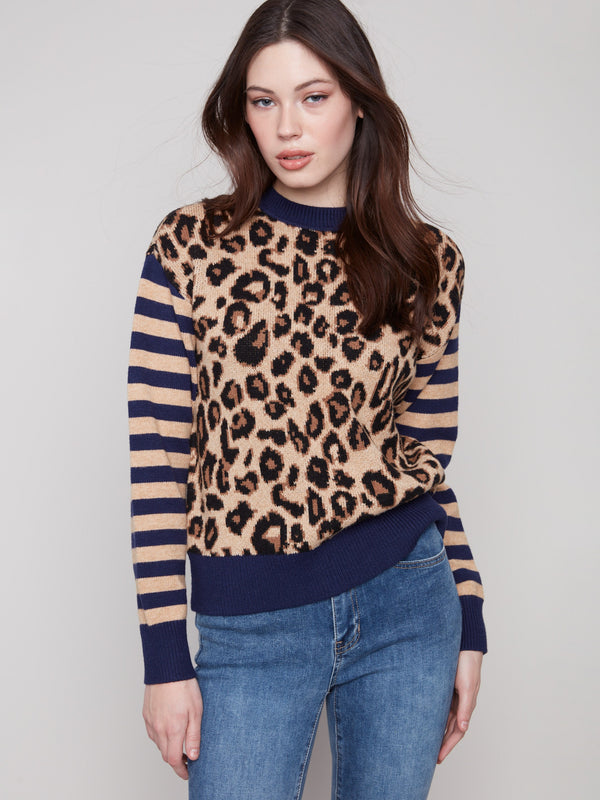 Casual chic sweater showcasing drop shoulders and vibrant leopard pattern paired with elegant stripes by Charlie B.