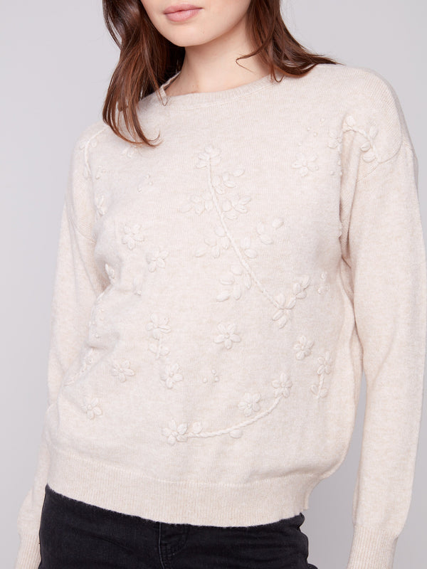 Beautiful tonal floral embroidery adds subtle detail to this heather oat sweater by Charlie B.