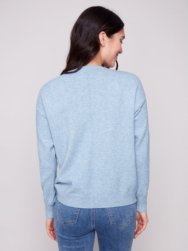 Heather oxford sweater highlighted by its drop shoulder style and subtle floral patterns by Charlie B.