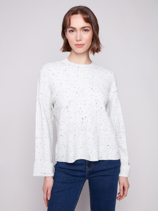 White sweater with a crew neck and speckled pattern, featuring a drop shoulder design by Charlie B.