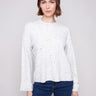 White sweater with a crew neck and speckled pattern, featuring a drop shoulder design by Charlie B.
