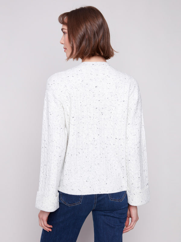 Elegant white sweater showcasing a drop shoulder design and speckled texture by Charlie B.