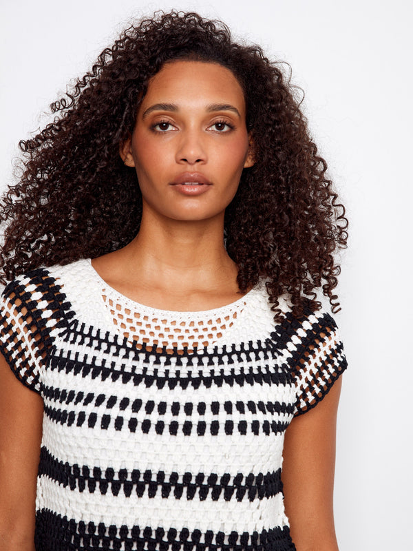 This stylish top boasts raglan cap sleeves, adding a modern touch to the classic black and white stripe pattern by Charlie B.