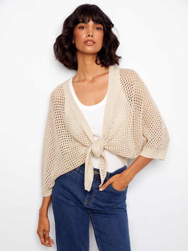 Beige crochet shrug with elbow dolman sleeves and a subtle metallic effect, perfect for layering by Charlie B.