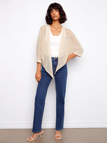 Chic beige crochet shrug with a subtle metallic sheen, ideal for adding texture to your outfit by Charlie B.