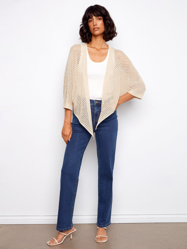 Chic beige crochet shrug with a subtle metallic sheen, ideal for adding texture to your outfit by Charlie B.