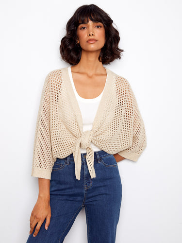 Lightweight crochet shrug in beige showcasing an adjustable tie-front detail and stylish design by Charlie B.