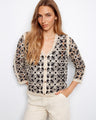 Crochet cardigan with intricate floral pattern and V-neck design, perfect for adding elegance to any outfit by Charlie B.