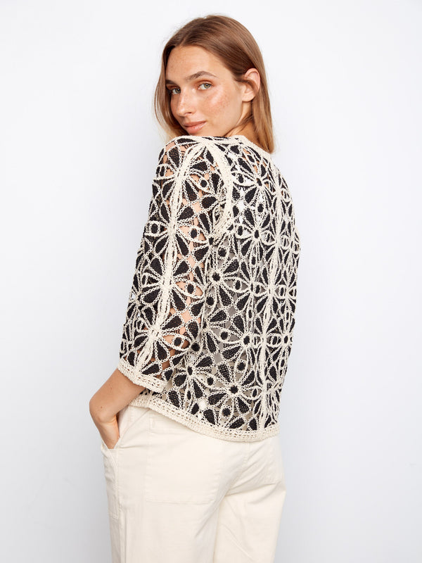 Elegantly designed crochet cardigan showcasing a delicate floral motif and comfortable fit, ideal for layering by Charlie B.