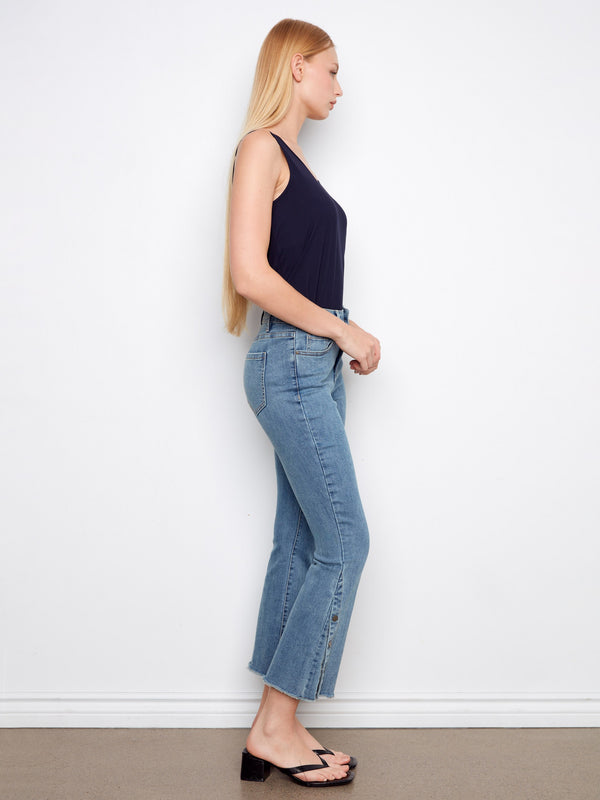 Experience the comfort of stretch denim in these blue cropped bootcut jeans, complete with side snaps at the hem by Charlie B.