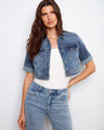 This chic cropped denim jacket showcases short rolled sleeves and chest pockets, ideal for layering by Charlie B.