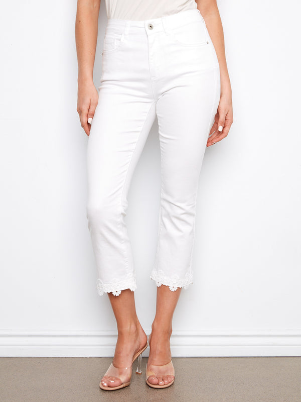 Cropped length white pants with floral hem trim, adding elegance to your style by Charlie B.