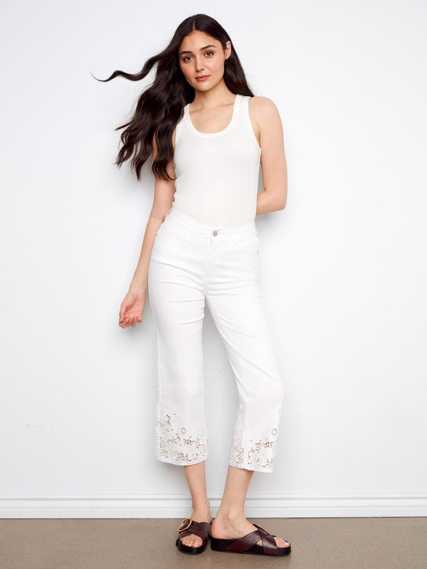 With a laser-cut lace hem, these elegant white cropped pants are ideal for adding flair to any outfit by Charlie B.