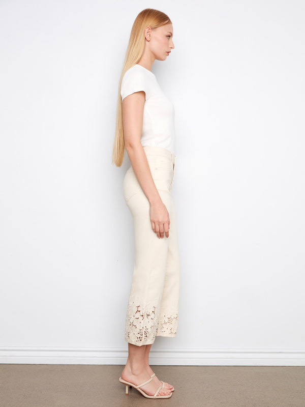Elegant flared jeans in a cropped length, showcasing exquisite floral lace accents by Charlie B.