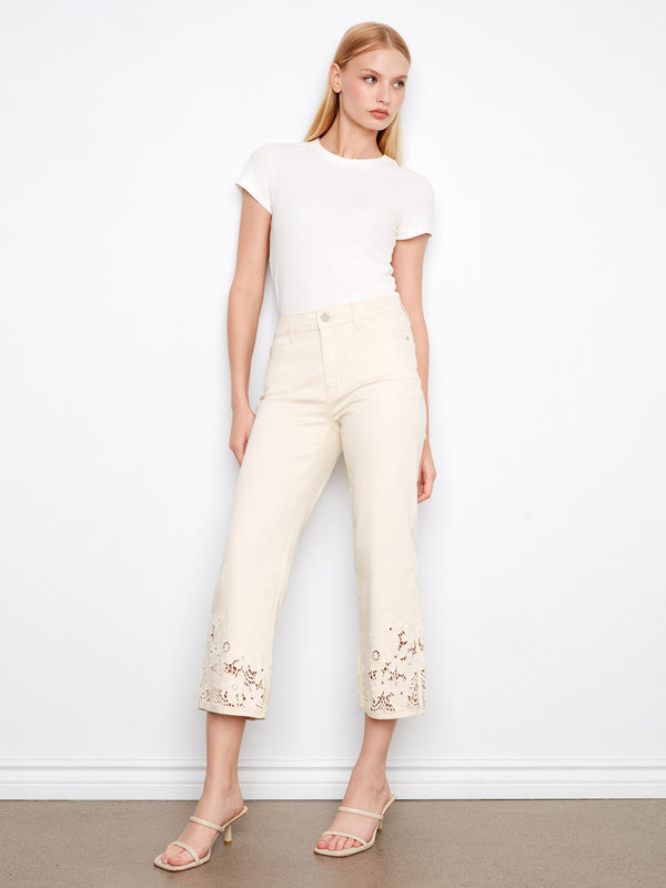 Trendy white flare jeans with laser-cut floral patterns, crafted for comfort in stretch twill by Charlie B.