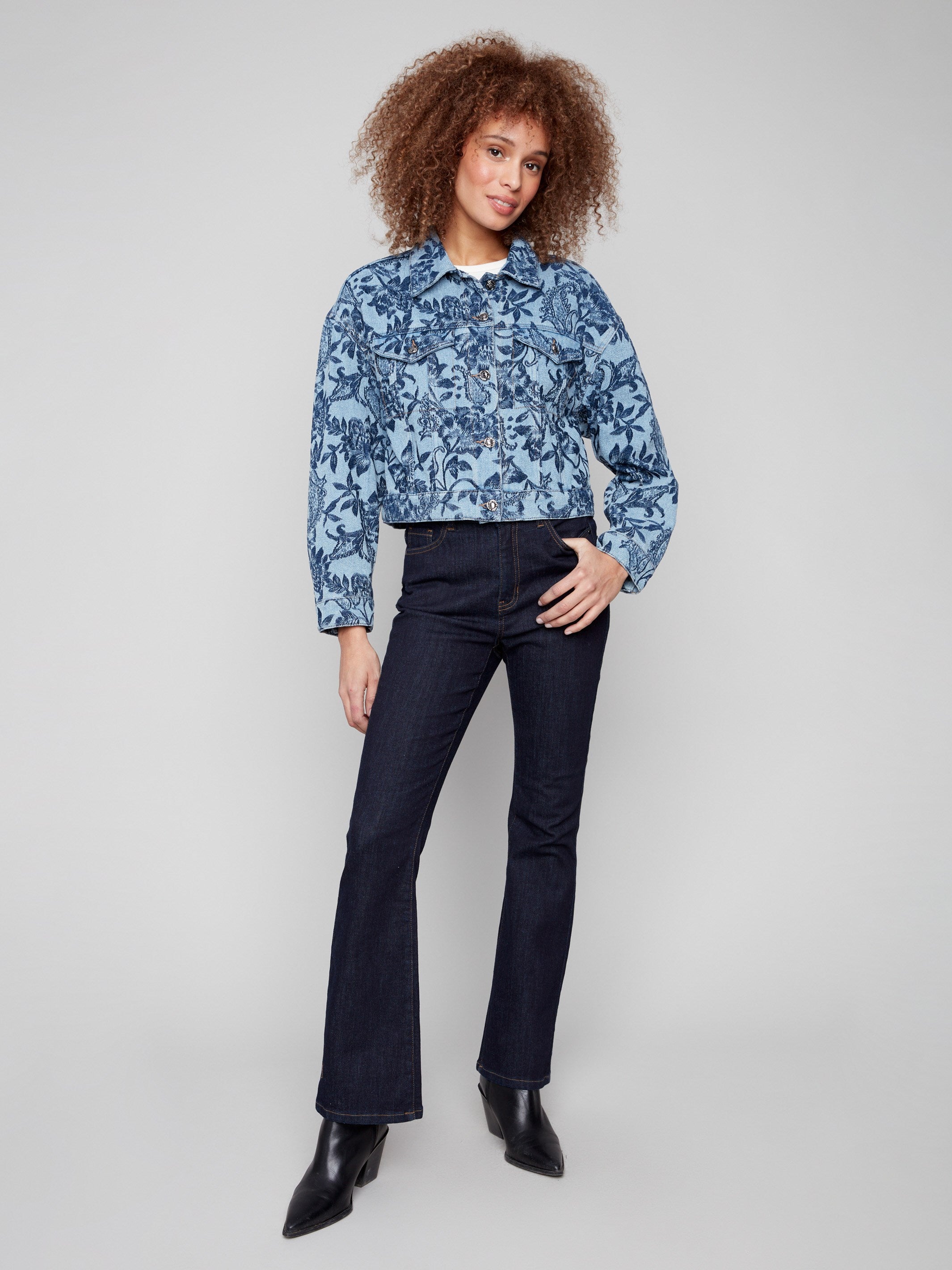 Chic cropped denim jacket with two convenient chest flap pockets and a beautiful floral design for added flair by Charlie B.